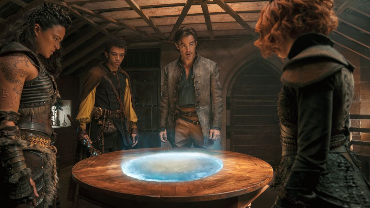 The Dungeons &amp; Dragons: Honor Among Thieves cast around a table with a portal in it.