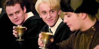 Tom Felton as Draco Malfoy holding a goblet