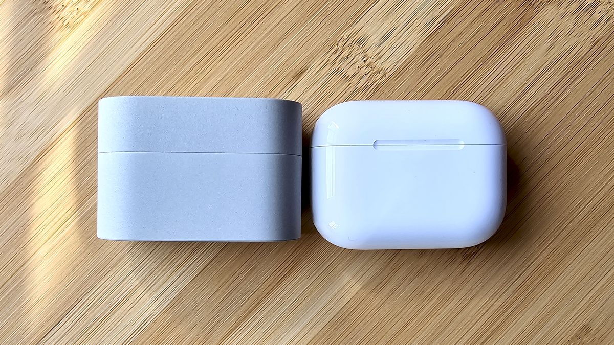 Sony WF-1000XM6 earbuds next to the Apple AirPods Pro 3, on a wooden table, in a versus-style format
