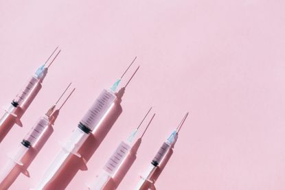 Syringes on a pink background