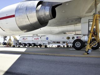 This image shows technicians and engineers at Vandenberg Air Force Base in California connecting the Pegasus XL rocket with the Interface Region Imaging Spectrograph, or IRIS, solar observatory to the Orbital Sciences L-1011 carrier aircraft. This image was released June 19, 2013.