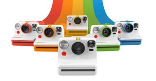 Six Polaroid Now cameras at the end of a rainbow. 
