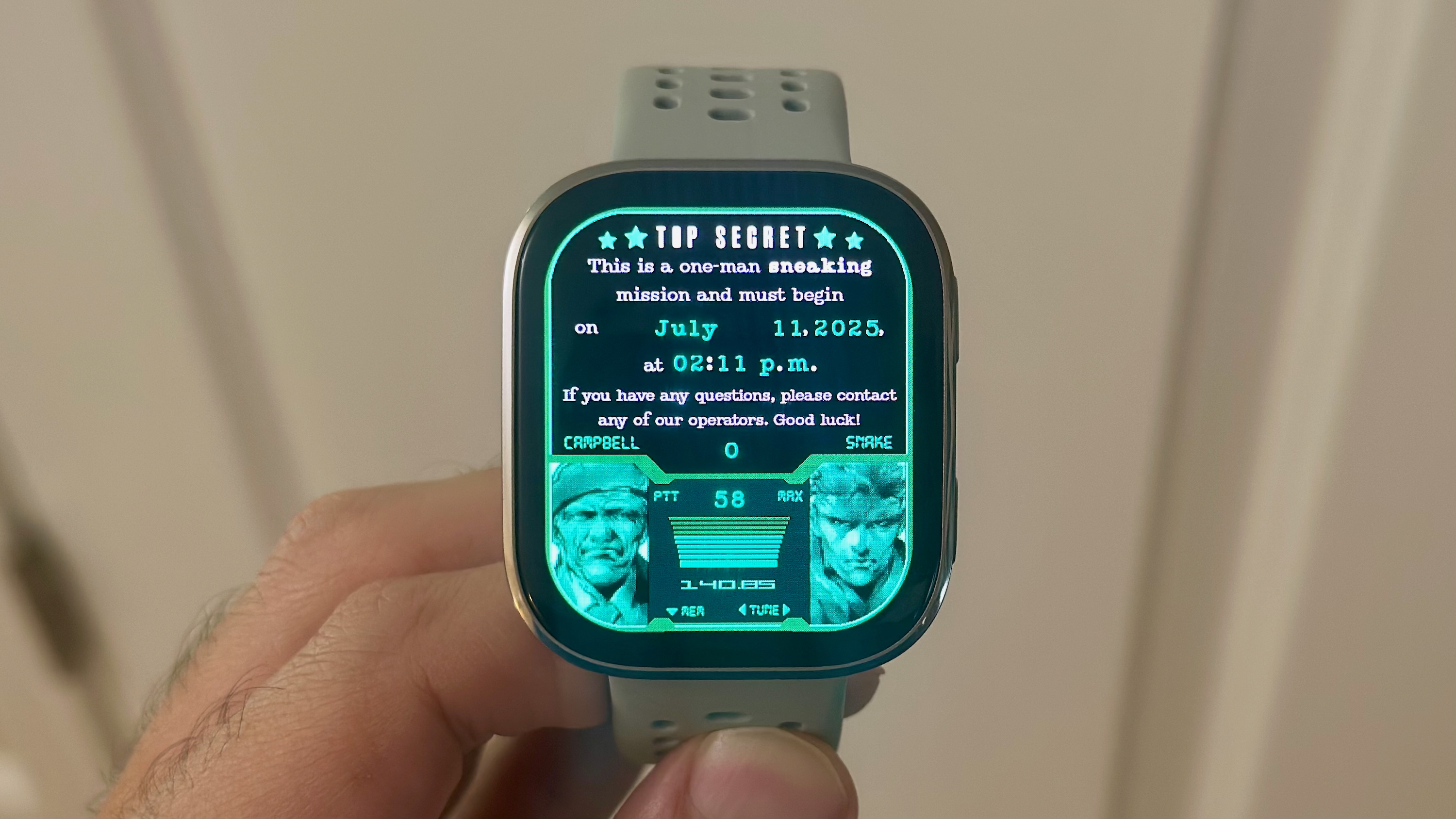 A photo close-up of the Amazfit Bip 6 held in hand, showing a custom watch face based on the game Metal Gear Solid with characters from the game.