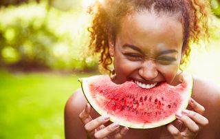 Young woman eating watermelon