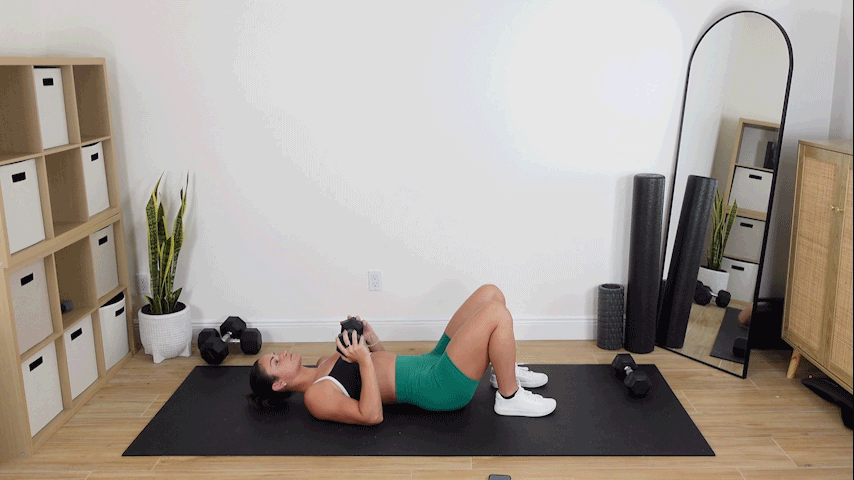 trainer Kirra Mitlo doing weighted glute marches with a press