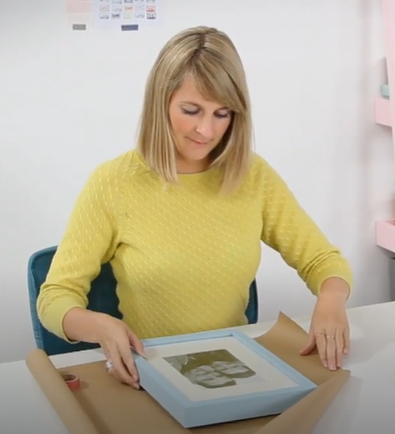 white room with picture displays on table