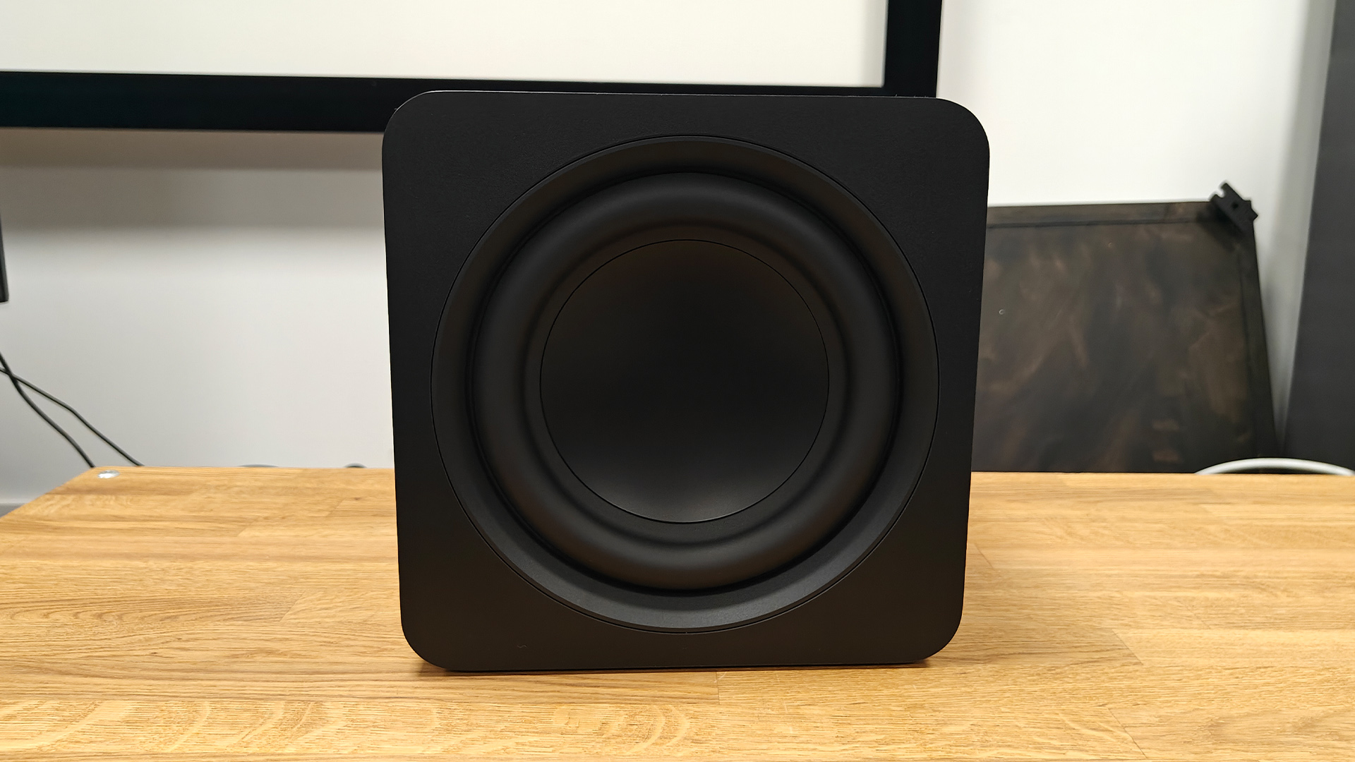 Samsung HW-QS700F Dolby Atmos soundbar subwoofer on wooden surface