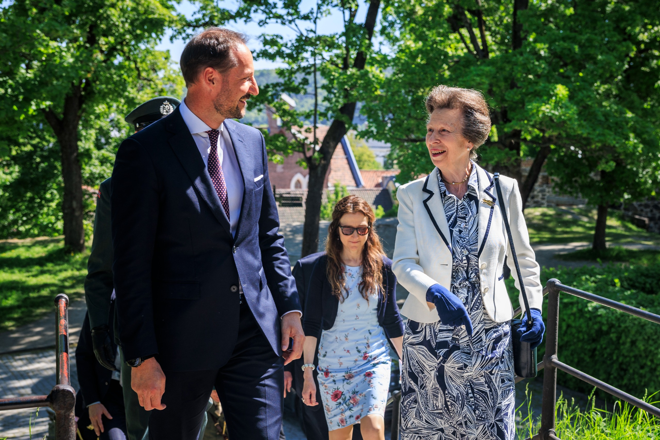 King Haakon smiling and talking to Princess Anne