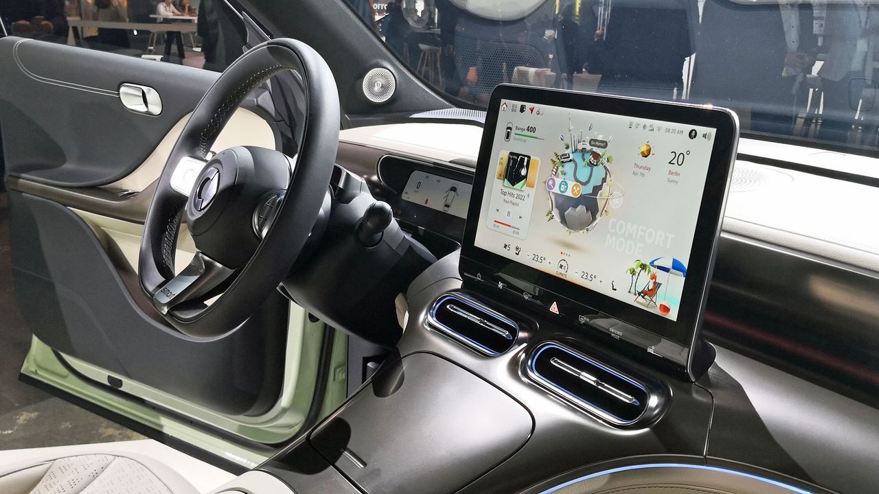 View of central display and steering wheel from the front passenger seat