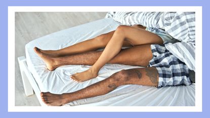 couples legs intertwined with each other in bed with blue border around the image, to illustrate legs shaking after sex
