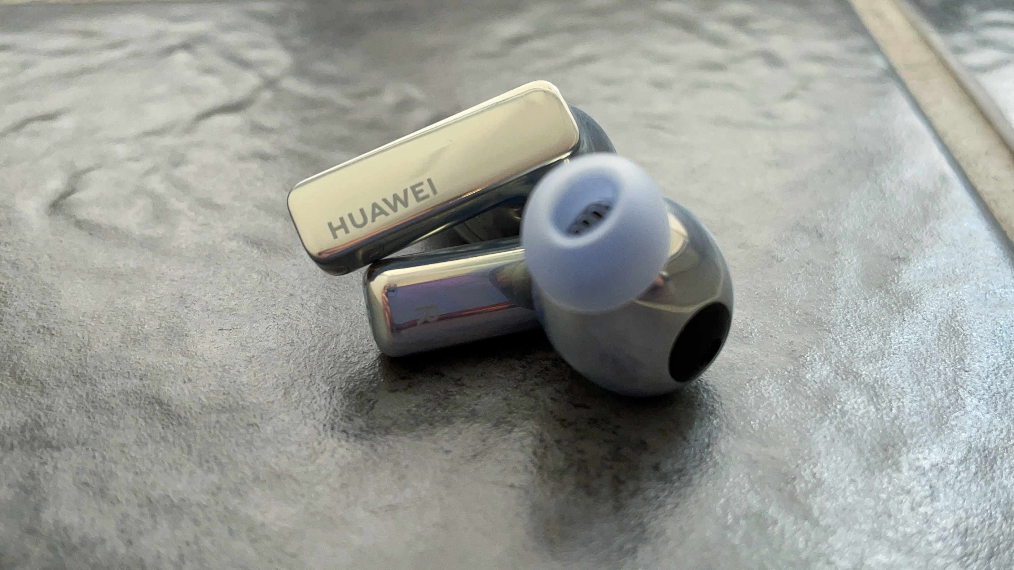 Huawei Freebuds Pro 2 on gray tiled background