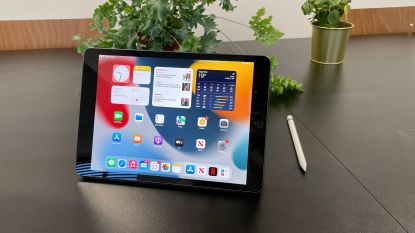 Apple iPad 10.2-inch (9th Gen) review, showing the tablet on a table, in landscape mode, with the Apple Pencil next to it
