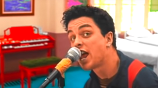 Billie Joe Armstrong sings while performing "Basket Case" for the music video.