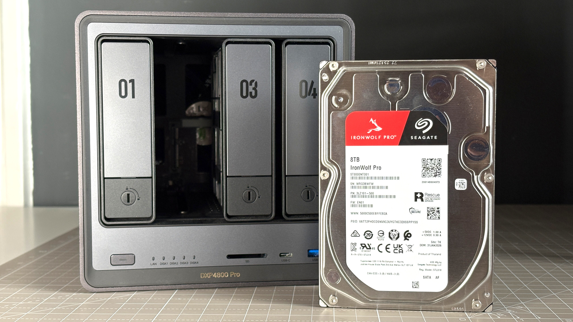 UGreen NASync DXP4800 Pro on a desk with multiple HDDs installed.