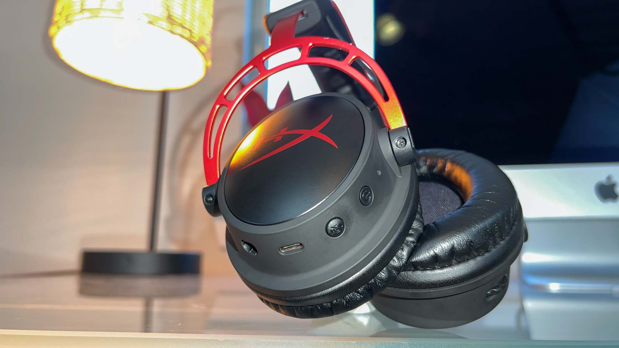 A HyperX Cloud Alpha Wireless gaming headset on a glass table