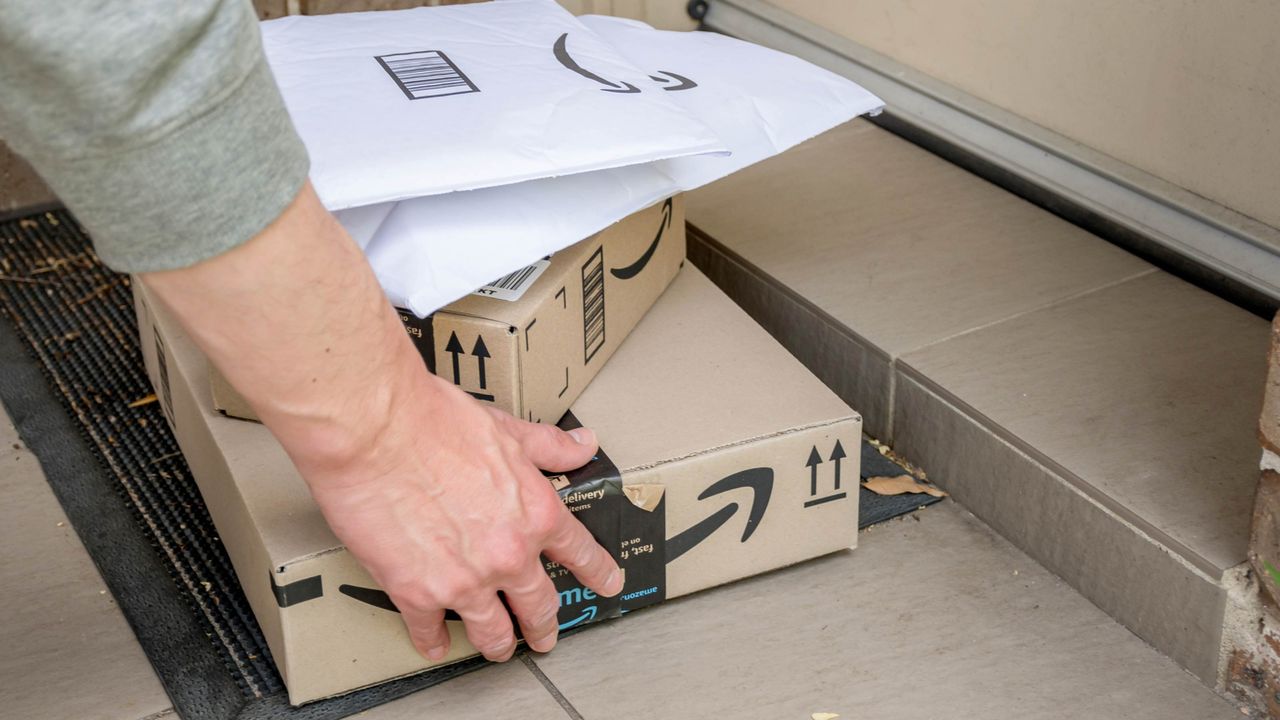 Amazon delivery of a stack of packages to a front porch