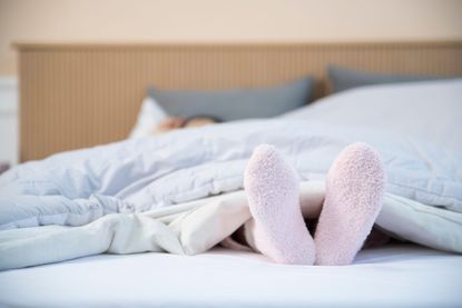 Socks in bed on mattress cover