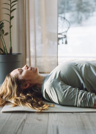 Woman lying on the floor during a yoga class