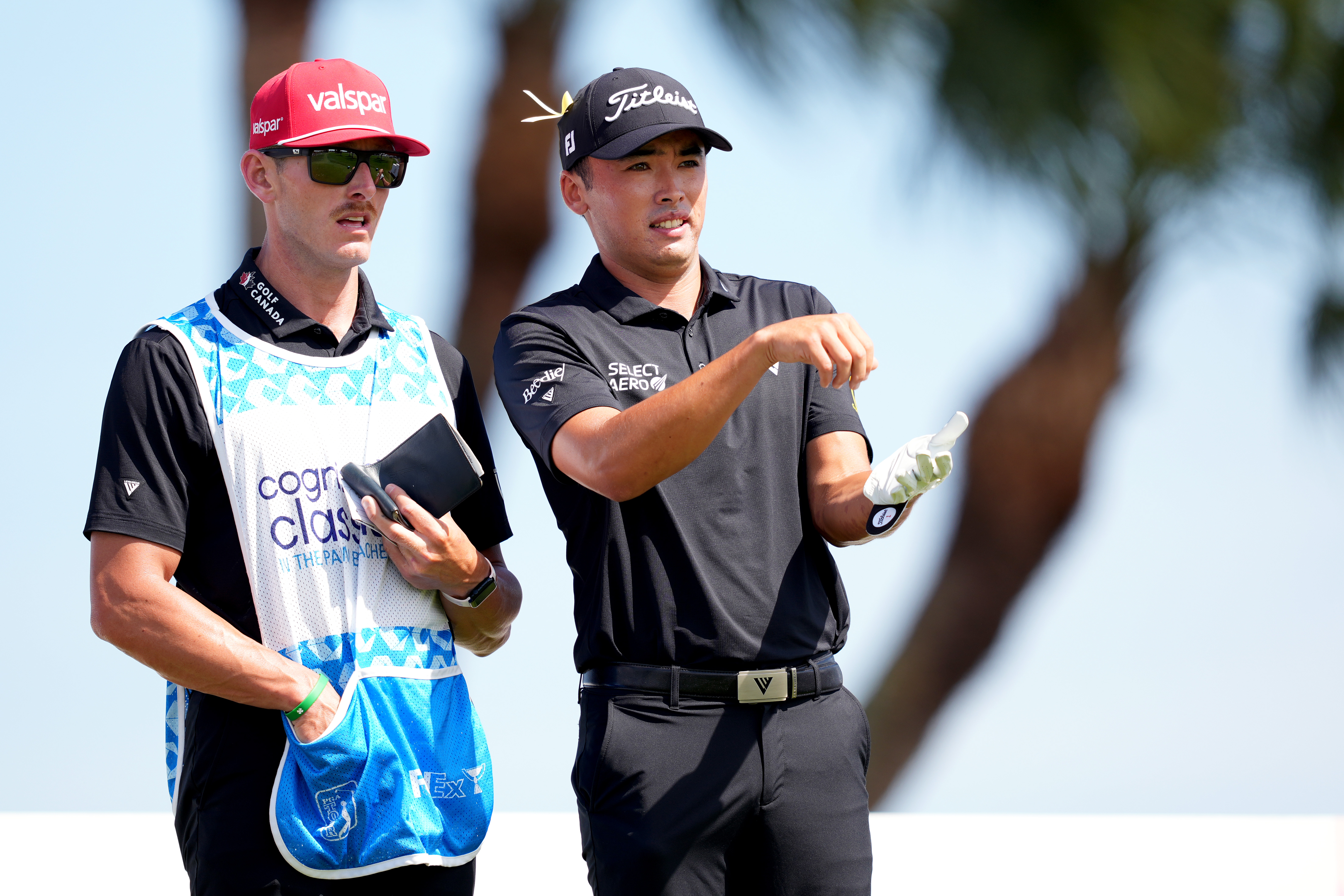 AJ Ewart speaks to his caddie