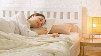 Woman sleeping on her side in bed