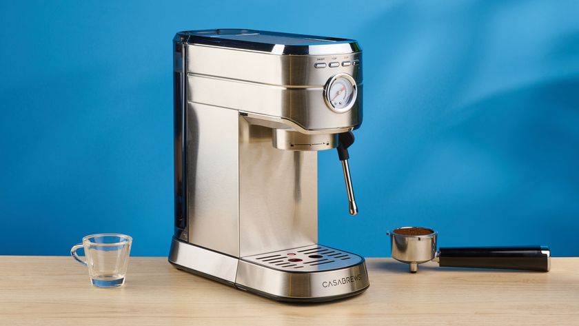 the casabrews cm5418 espresso machine in silver showing its steam wand and water tank and accessories
