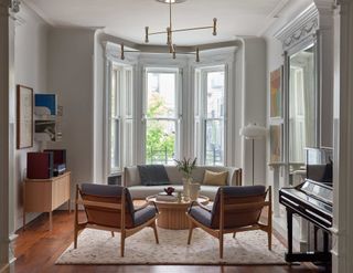 A living room with bay window and conversational seating