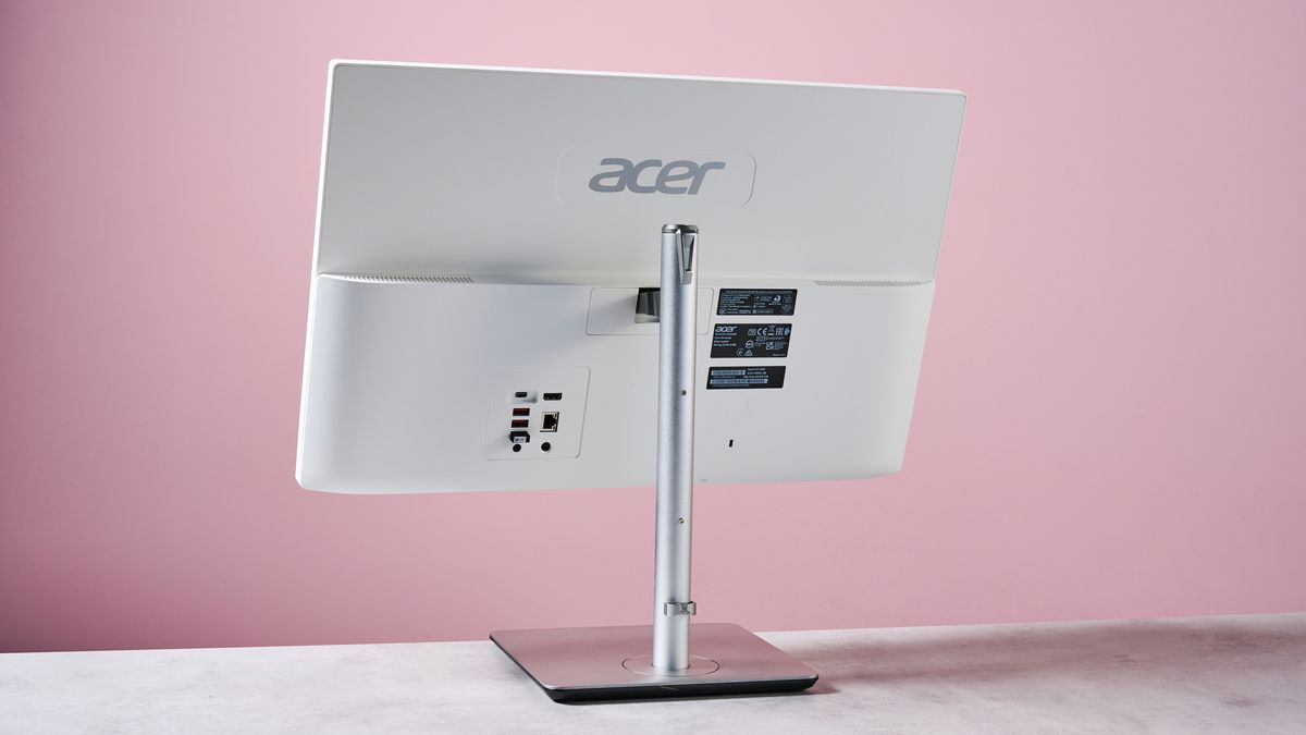 Back of Acer Aspire C24, on desk against a pink background