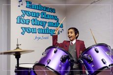 A boy playing the drums in front of a wall with the quote 'Embrace your flaws, for they make you unique'