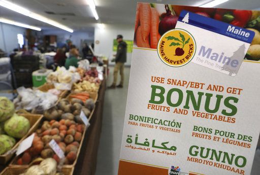 In this Friday, March 17, 2017 photo a sign advertises a program that allows food stamp recipients to use their EBT cards to shop at a farmer&amp;#039;s market in Topsham, Maine. 