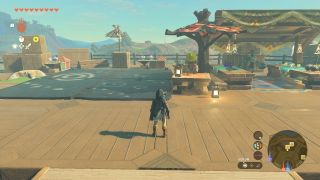 Link stands in front of Pelison in Tarrey Town in The Legend of Zelda Tears of the Kingdom.