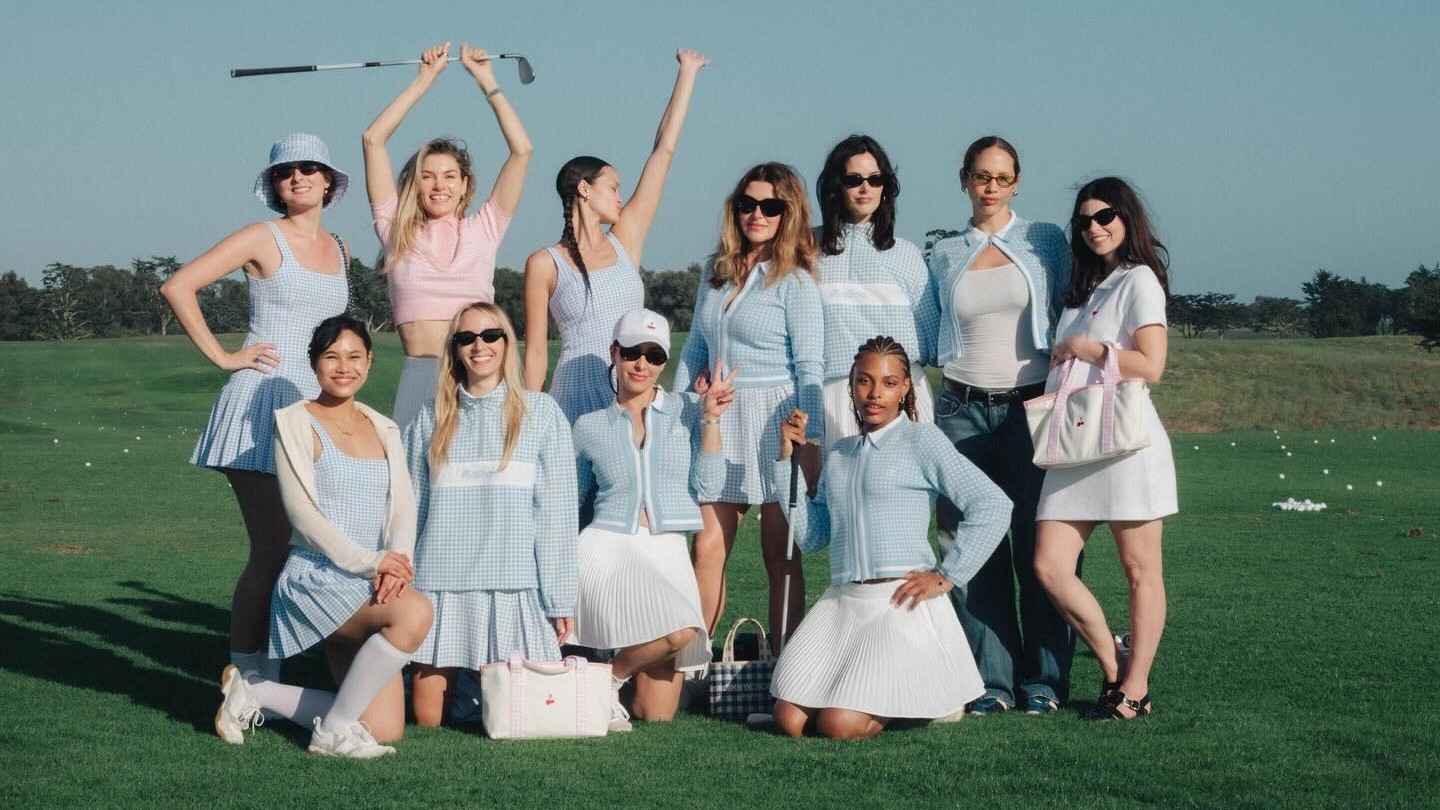 A group of women model the HVN x Malbon golfwear collab.