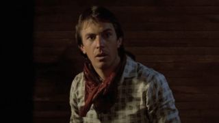 Kevin Costner as Jake wearing a bandana around his neck in a jail cell in Silverado