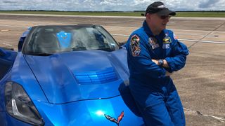 Retired NASA astronaut Scott Kelly poses with his blue C8 Corvette, which Chevrolet unveiled Thursday, July 18, 2019, in Tustin, California, just ahead of the 50th anniversary of the Apollo 11 moon landing.