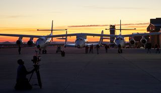 Preparations for SpaceShipTwo's first solo glide flight are almost complete as the sun rises over the Mojave Air and Space Port in California on Oct. 10, 2010.