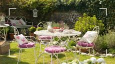 picture of white metal dining set in a garden with eating utensils on top of it to show good garden furniture placement 