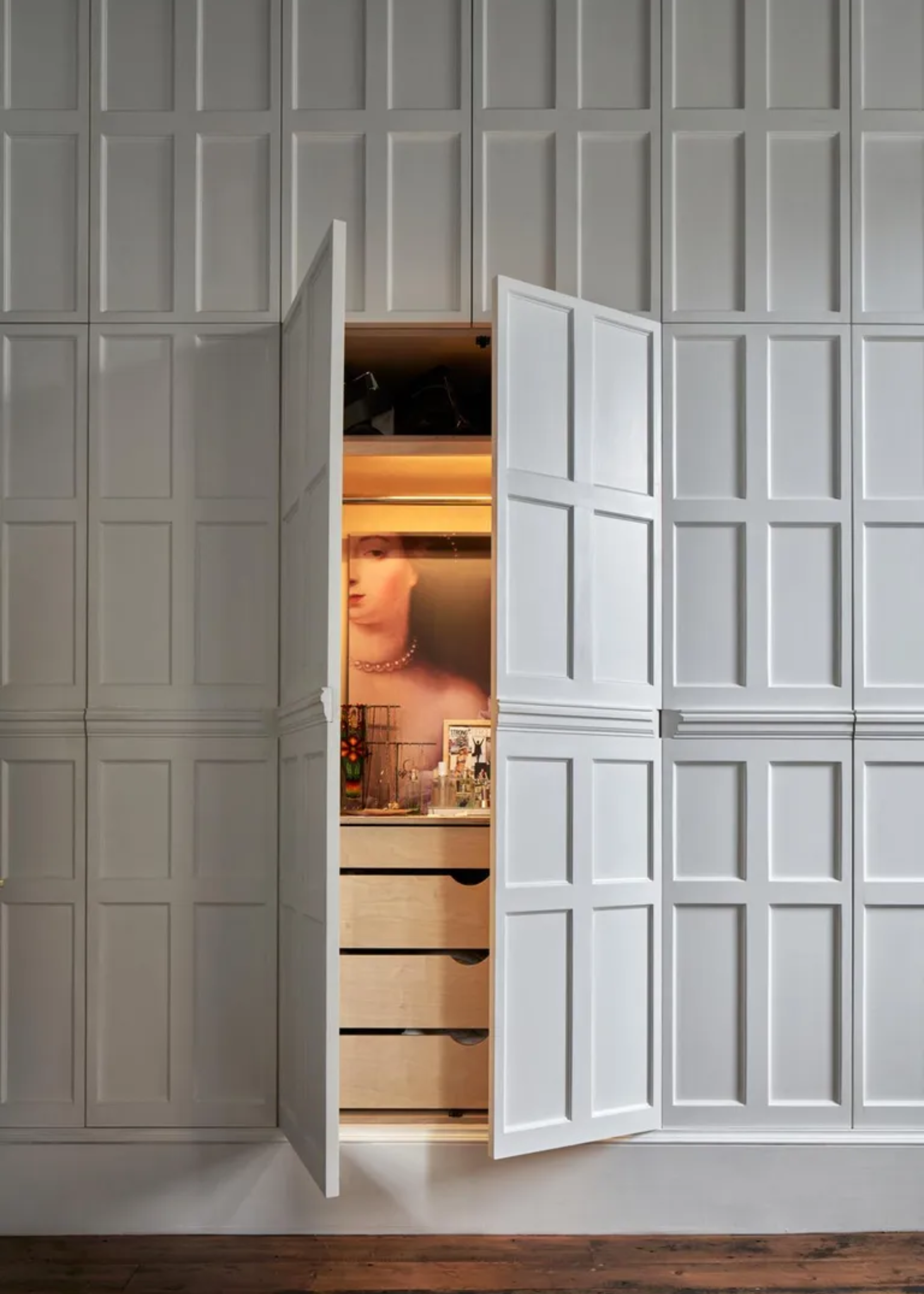 A covert closet with wood drawers and a counter for jewellery