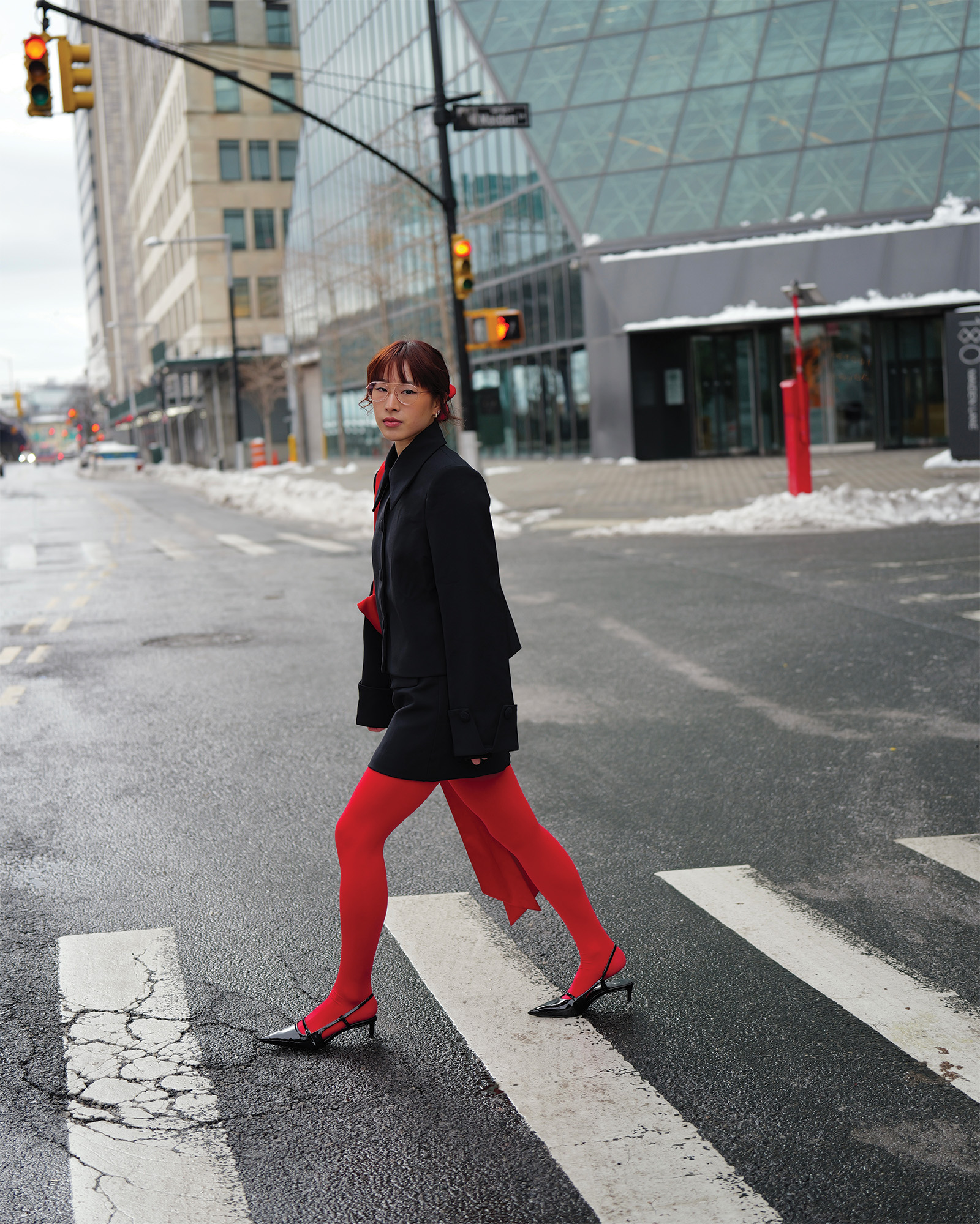 Who What Wear Editor in Residence Kristina Ang wearing a black set with red tights.