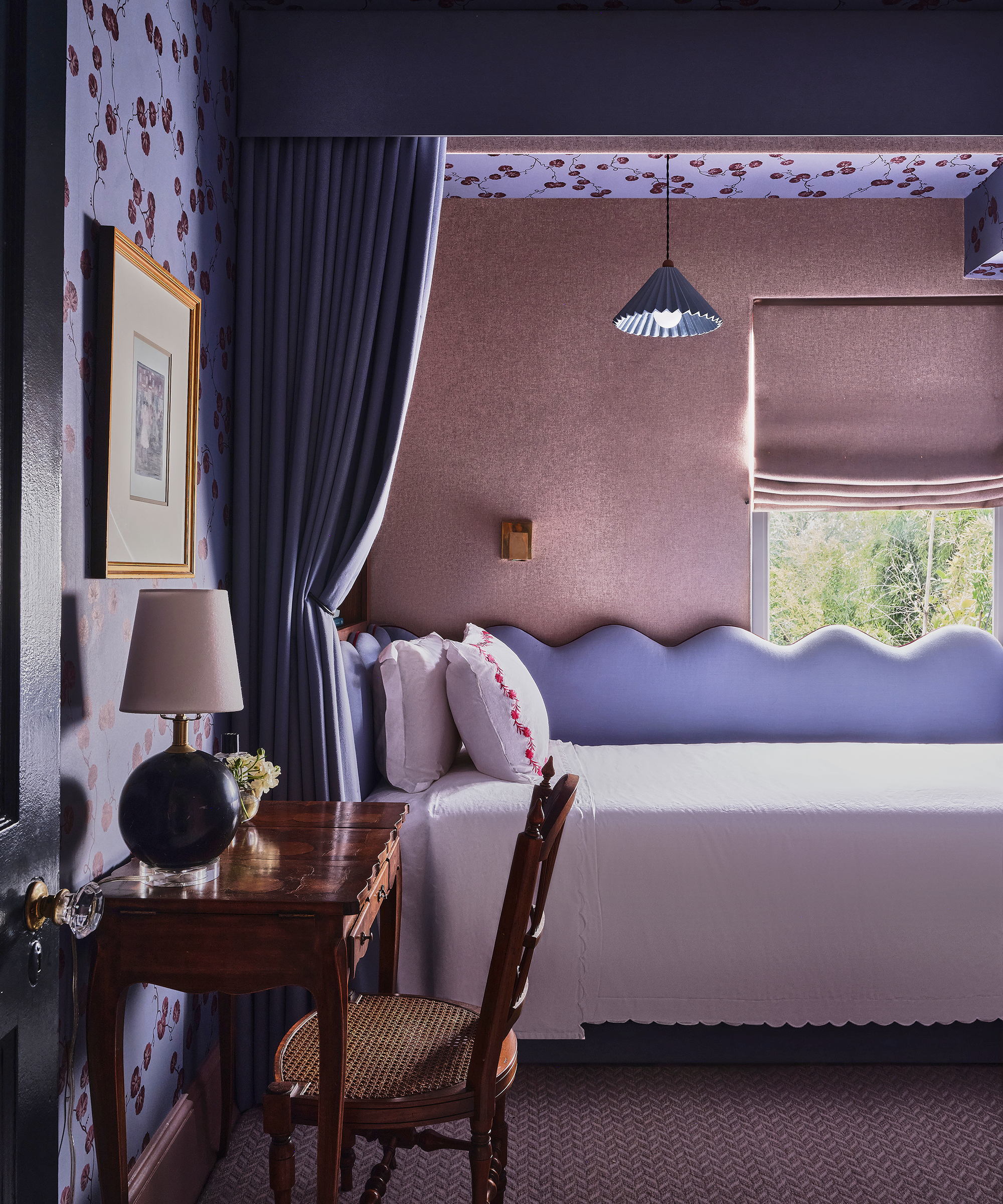 purple bedroom with canopy above the bed and curtain hanging down 