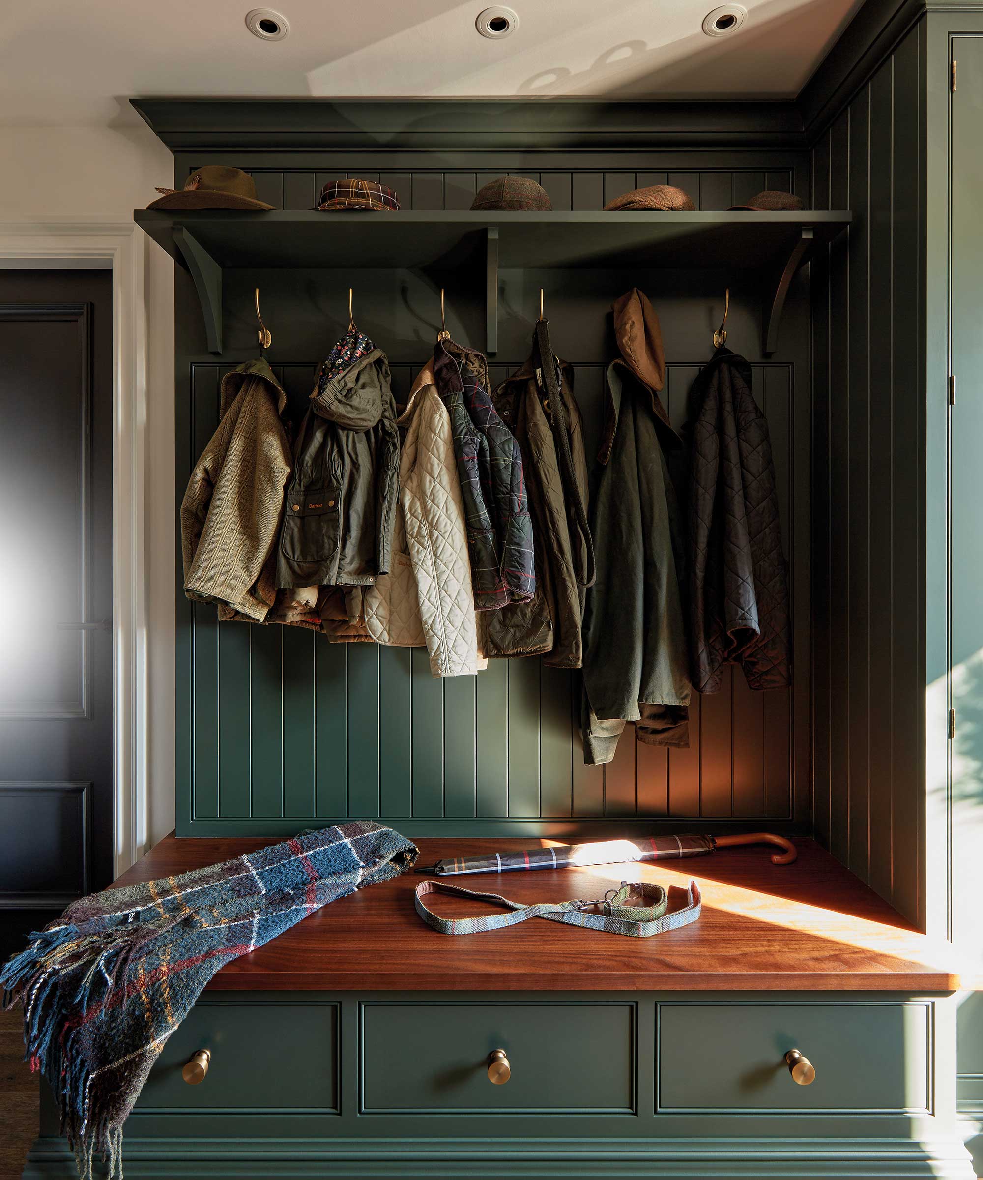 dark green boot room storage with storage bench with drawers and coat hooks