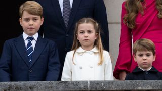 Prince George, Princess Charlotte and Prince Louis stand on the balcony at Buckingham Palace