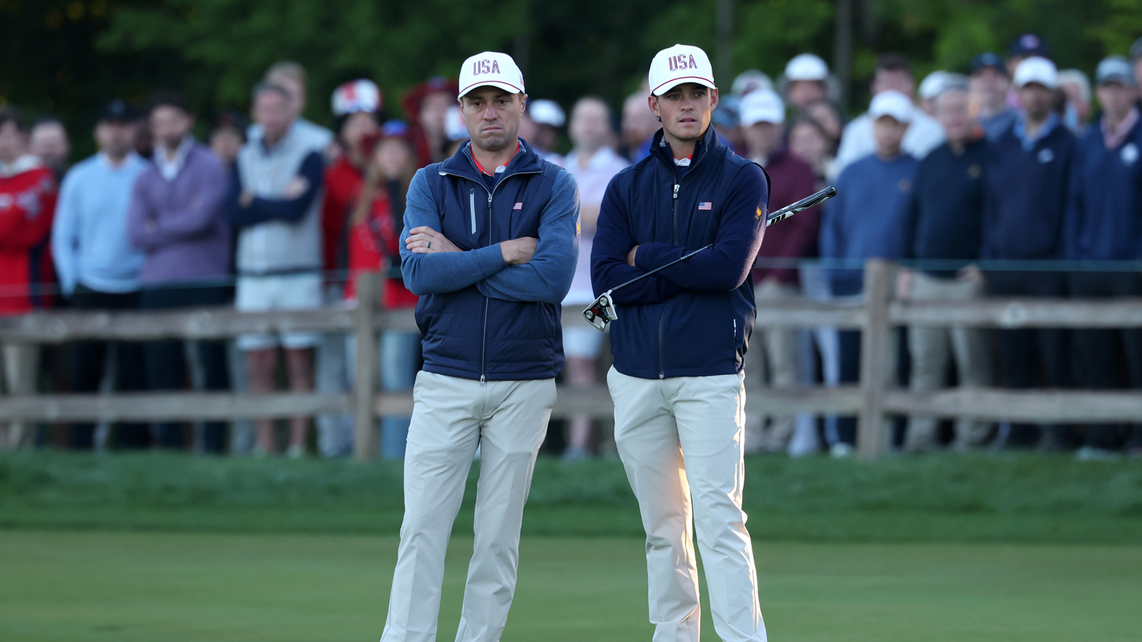 Justin Thomas and Jackson Koivun look on