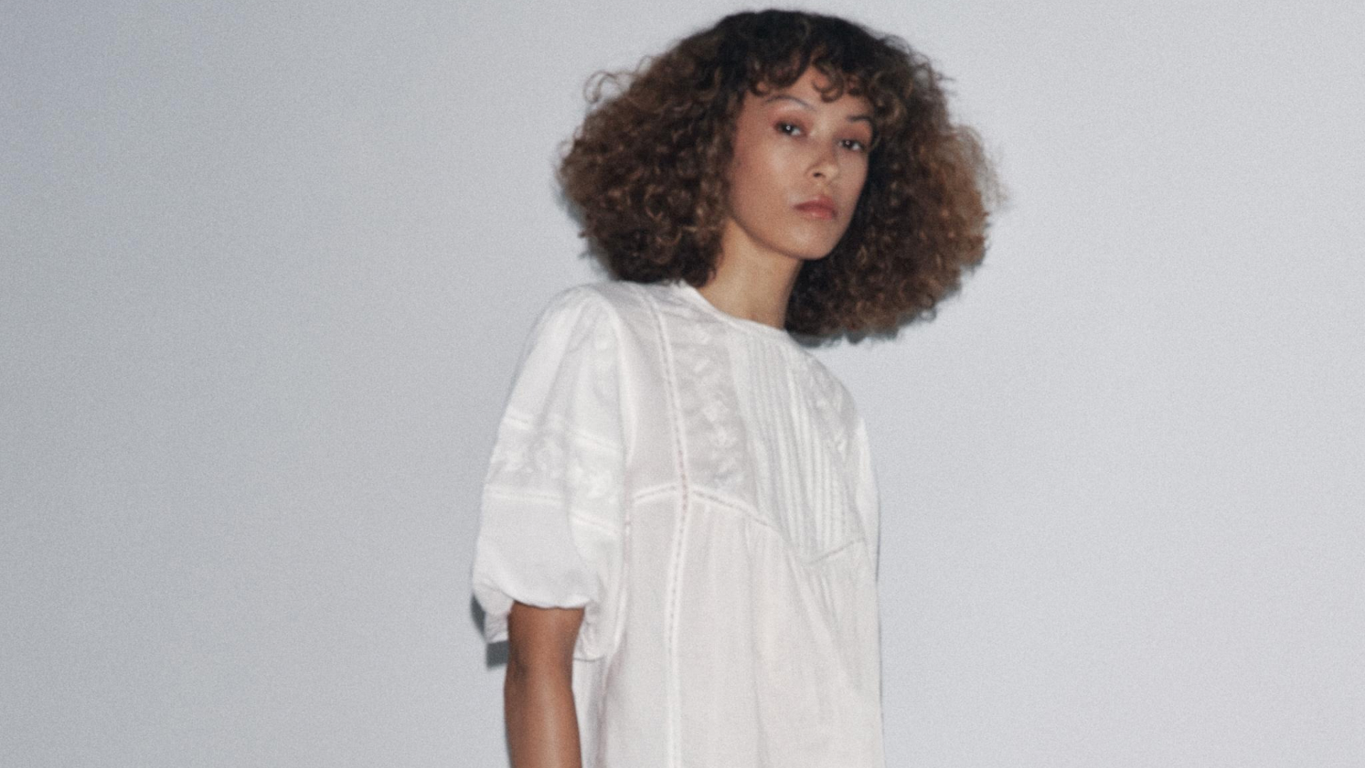 Zara model wearing the Zw Collection Embroidered Romantic Blouse on grey background