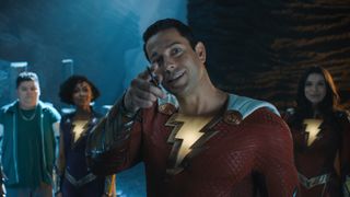 Shazam points at something as his sibling look on in Shazam! Fury of the Gods