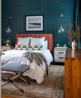 blue and terracotta bedroom with wall lights