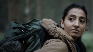 Ellora Torchia wearing a backpack outdoors in In the Earth