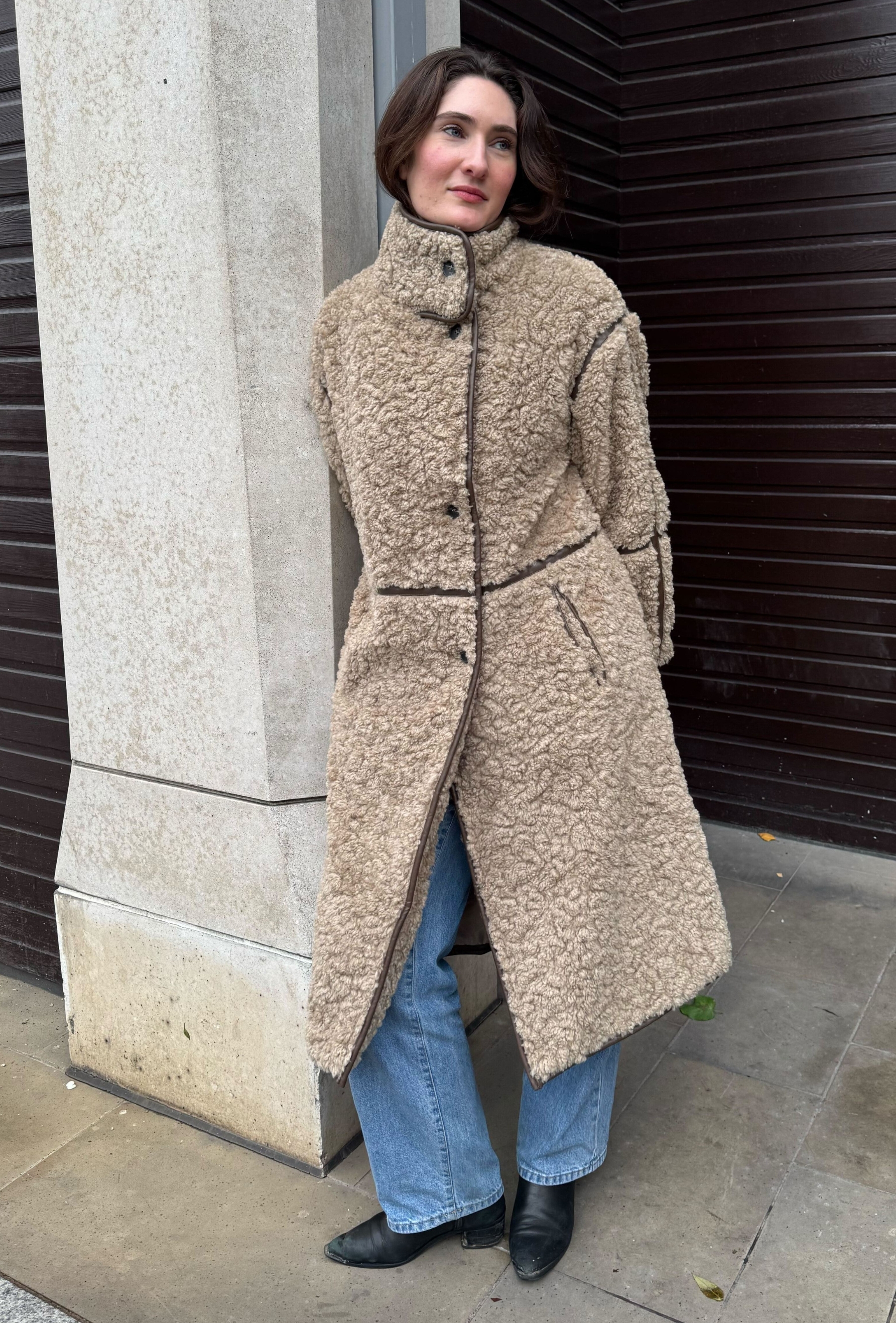 An editor from Who What Wear UK modelling a teddy coat