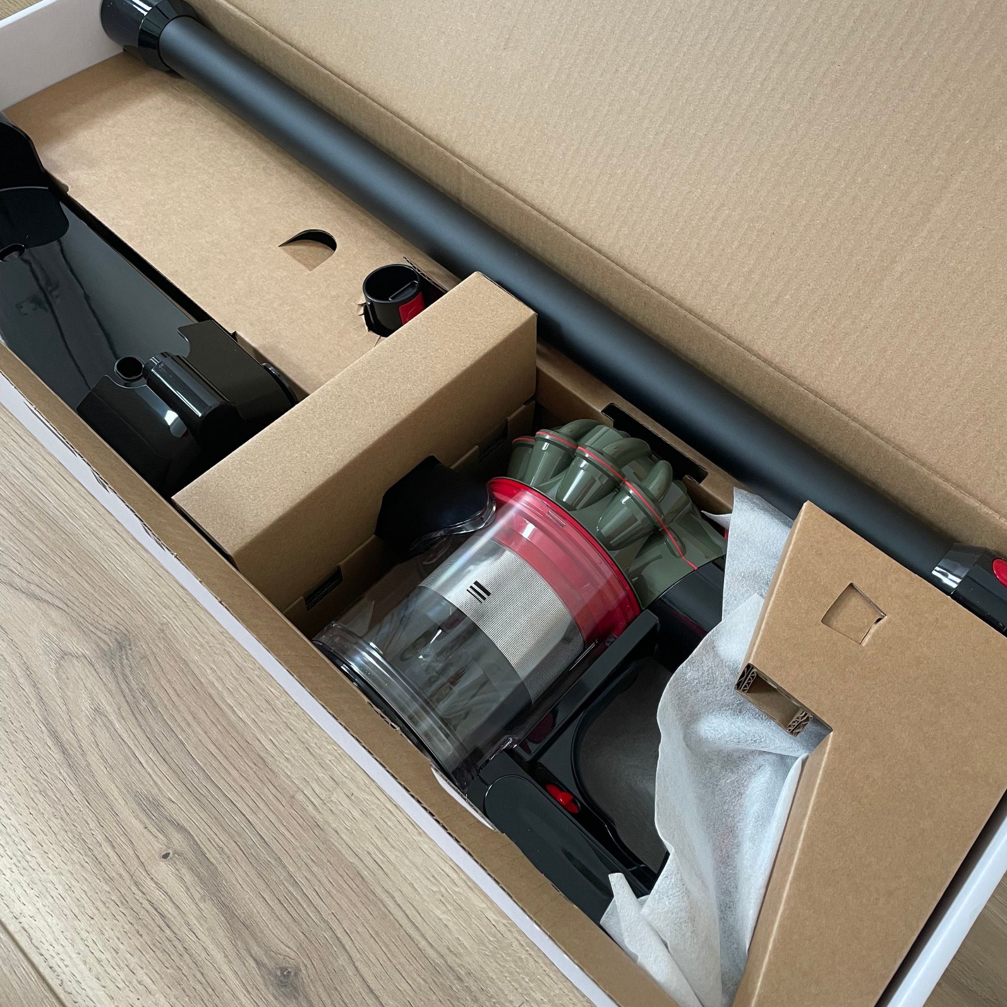 The components of the Dyson V8 Cyclone laying in the box