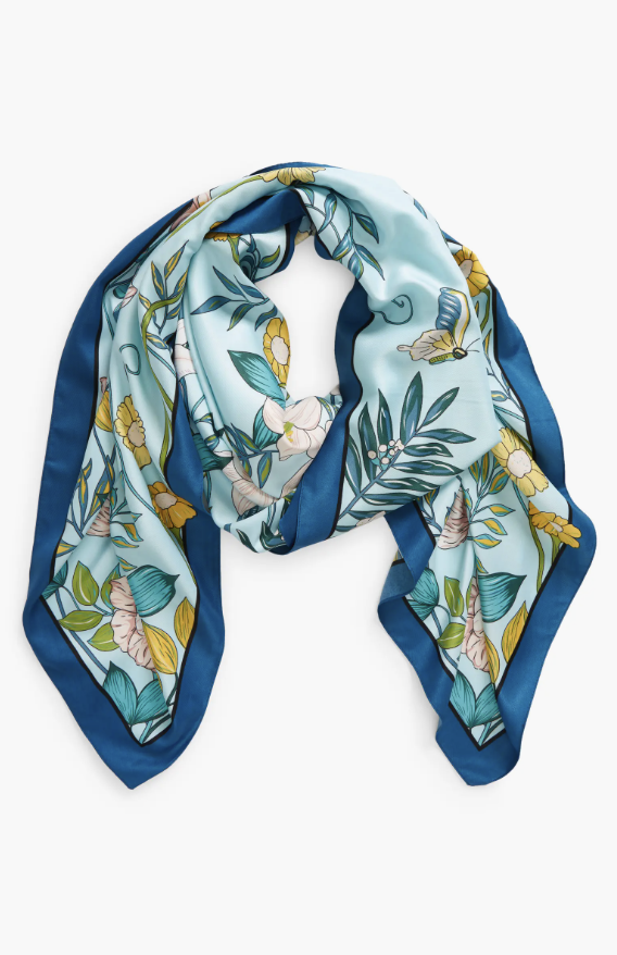 a floral scarf from nordstrom inspired by hailey bieber in front of a plain backdrop