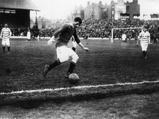 Billy Meredith in action for Manchester United against Queens Park Rangers in the first ever Charity Shield match in 1908.