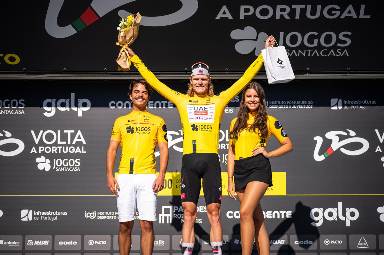 Julius Johansen (Den) UAE Team Emirates-XRG on the podium wearing the leader's jersey after the Volta a Portugal prologue